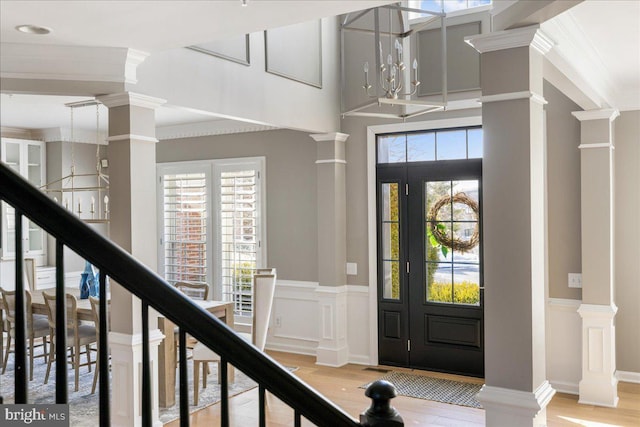 entrance foyer featuring ornamental molding and plenty of natural light