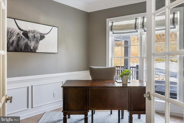 home office featuring ornamental molding and light hardwood / wood-style floors