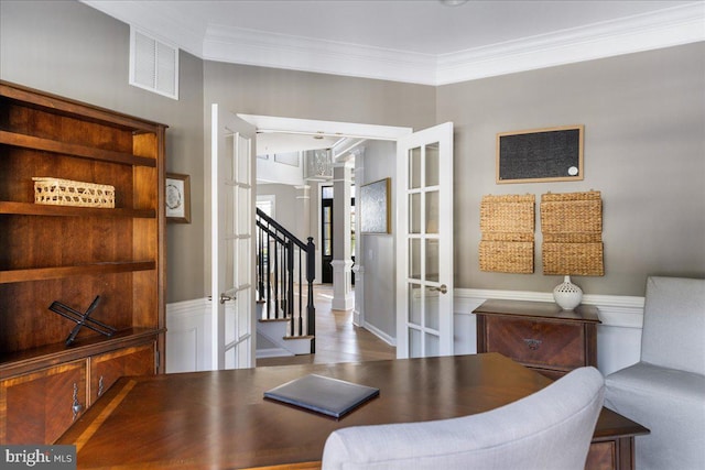 dining space with french doors and ornamental molding