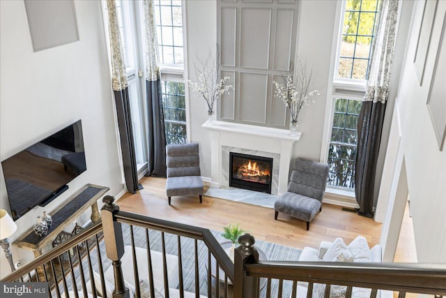 living area with a premium fireplace and hardwood / wood-style flooring