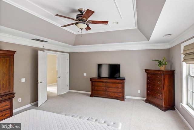 carpeted bedroom featuring a raised ceiling, ceiling fan, and crown molding