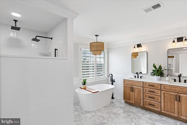 bathroom with vanity, ornamental molding, and independent shower and bath