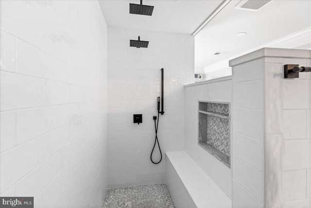 bathroom with a tile shower