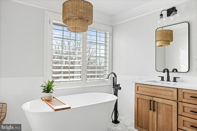 bathroom with tile walls, ornamental molding, a tub, and vanity