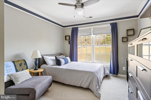 bedroom with ceiling fan, crown molding, and light colored carpet