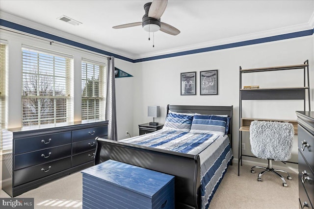 carpeted bedroom featuring ceiling fan and crown molding