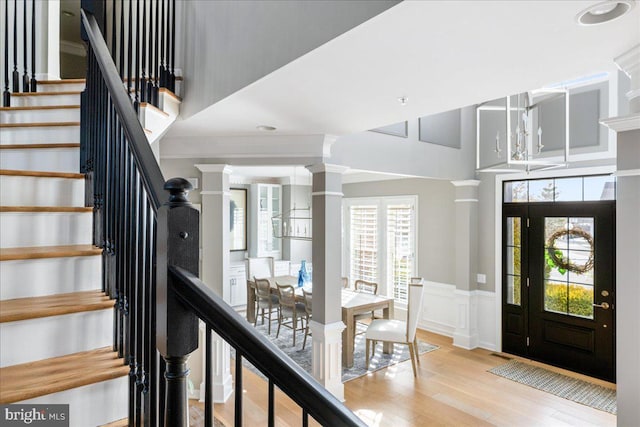 foyer with light hardwood / wood-style floors and a notable chandelier