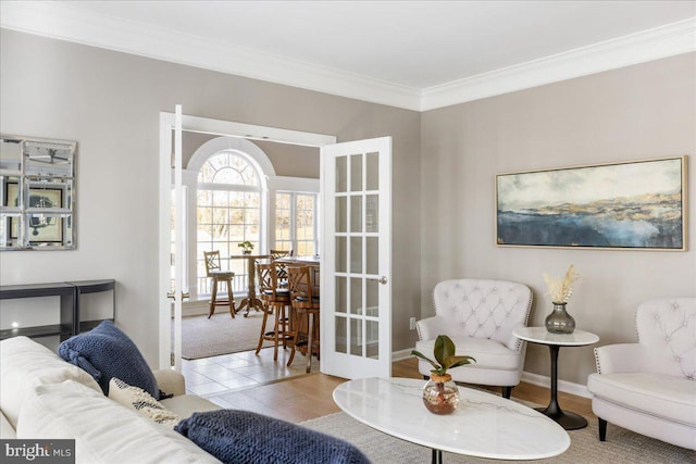 interior space with french doors, light hardwood / wood-style floors, and crown molding