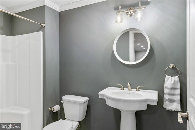 bathroom with toilet and crown molding