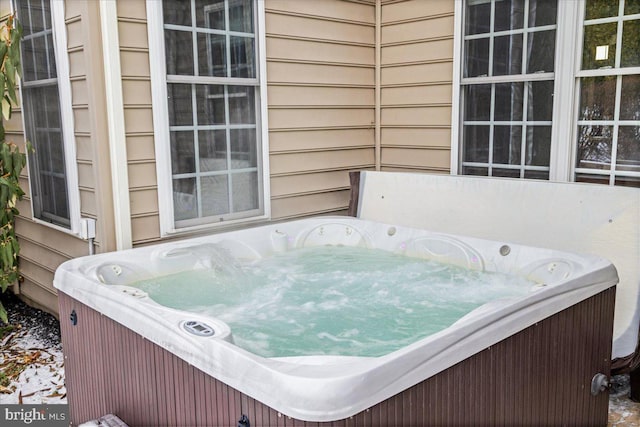 wooden terrace featuring a hot tub