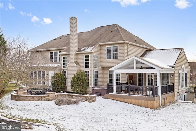 snow covered property featuring a hot tub