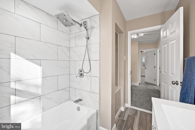 full bath featuring  shower combination, wood finish floors, and baseboards