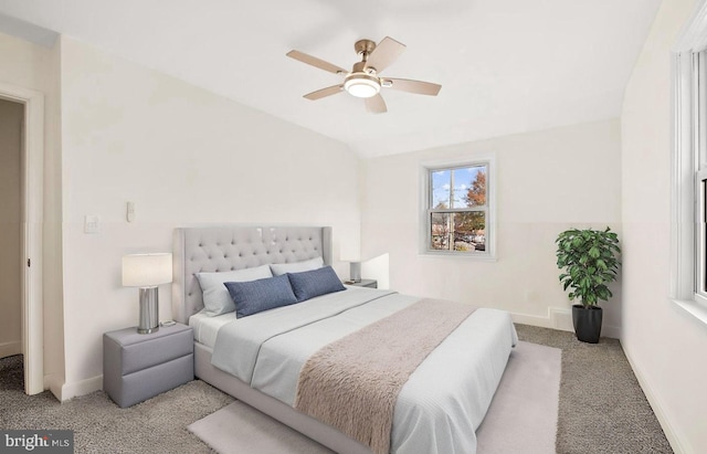 bedroom with ceiling fan, baseboards, vaulted ceiling, and carpet flooring