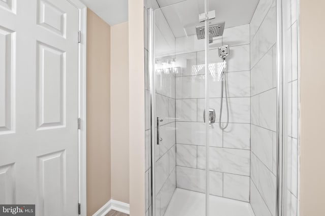 bathroom featuring a stall shower, baseboards, and visible vents