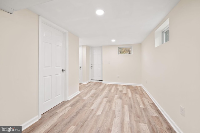 finished basement featuring light wood-type flooring, baseboards, and recessed lighting