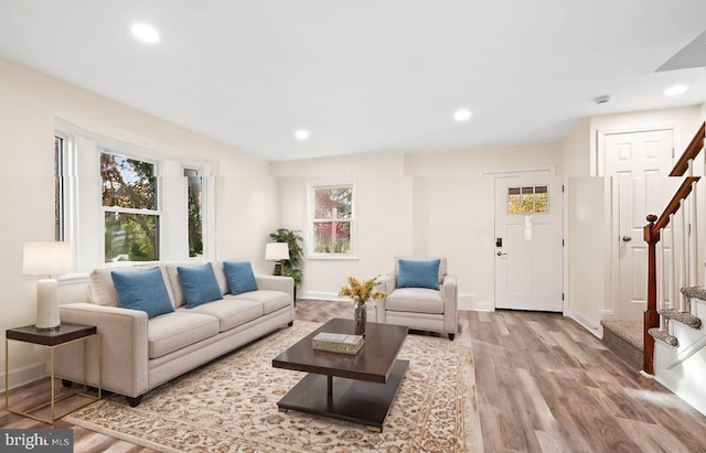 living area with stairs, baseboards, wood finished floors, and recessed lighting