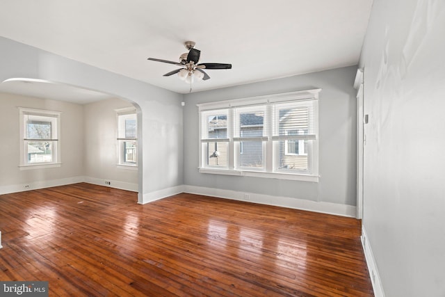 spare room featuring ceiling fan and dark hardwood / wood-style floors