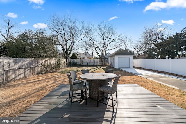 deck with a garage and an outdoor structure