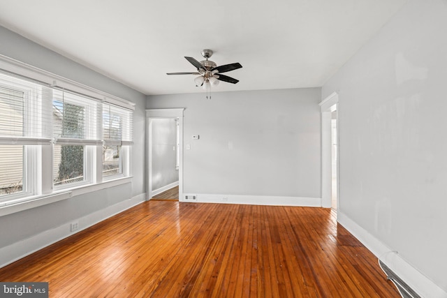 empty room featuring ceiling fan and hardwood / wood-style flooring