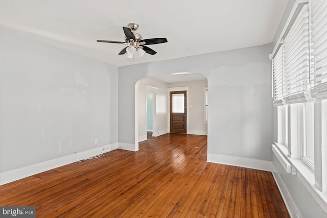 spare room featuring ceiling fan and dark hardwood / wood-style flooring