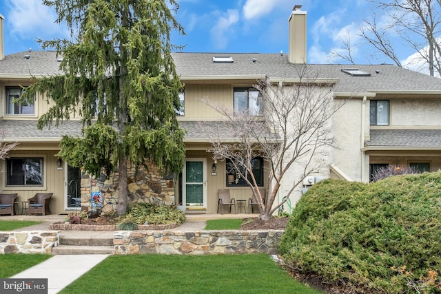 view of front of house featuring a front lawn and a patio