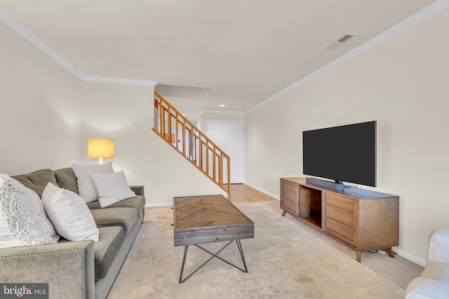 living room with light wood-type flooring and ornamental molding