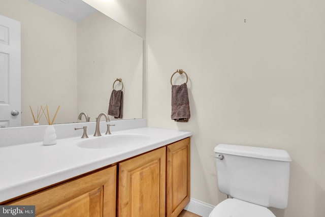 bathroom with toilet and vanity