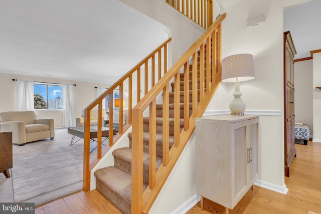 stairs featuring hardwood / wood-style floors