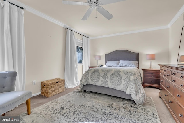 carpeted bedroom featuring ceiling fan and crown molding