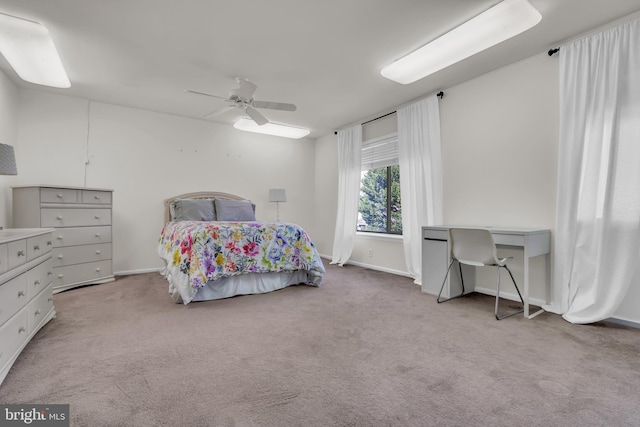 bedroom with ceiling fan and light colored carpet