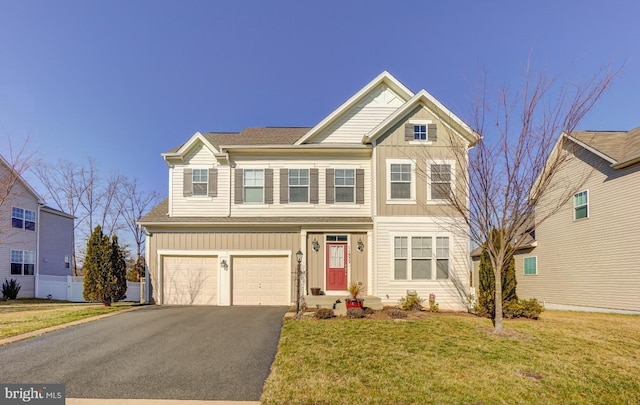 view of front of home with a front yard and a garage