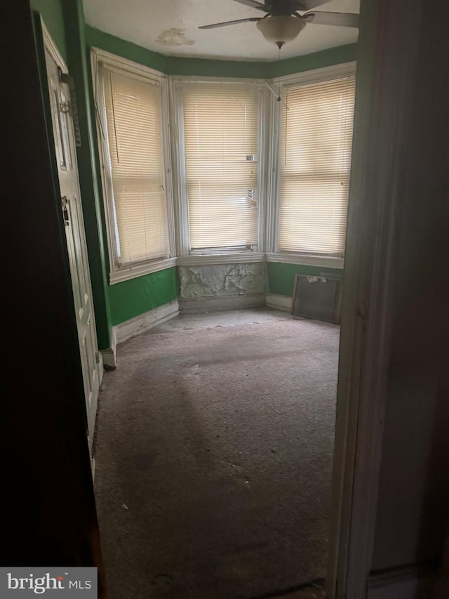 carpeted empty room with ceiling fan