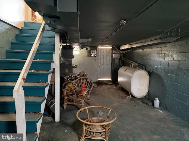 unfinished basement with stairs and heating fuel