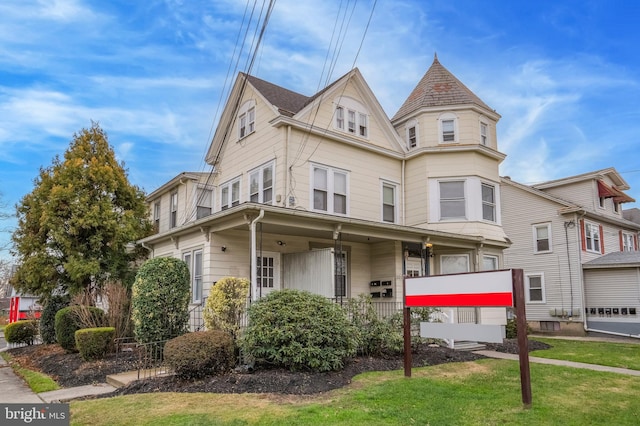 victorian home featuring a front yard