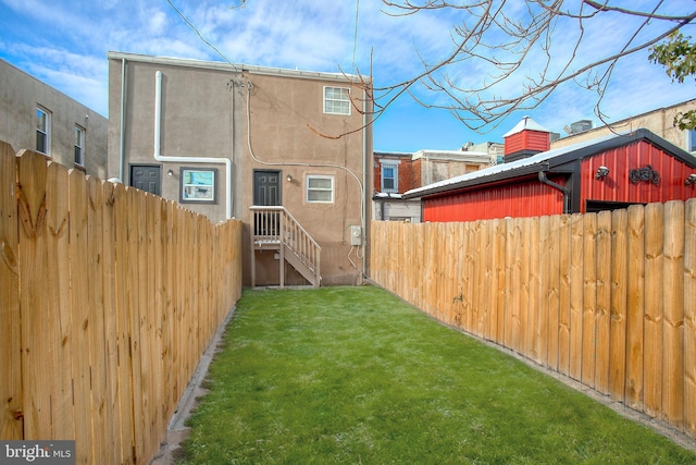 rear view of house featuring a lawn