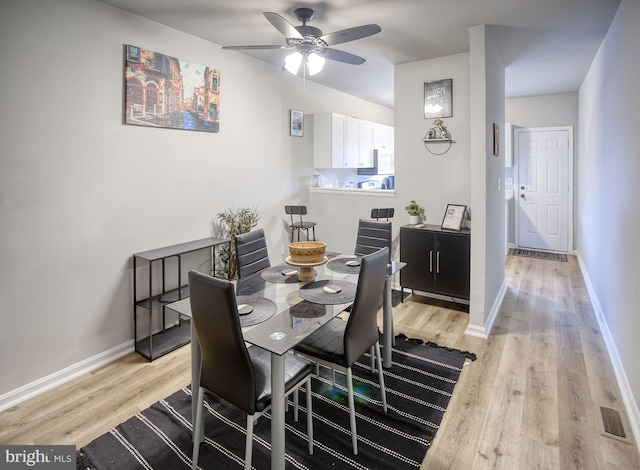 dining area featuring ceiling fan and light hardwood / wood-style floors