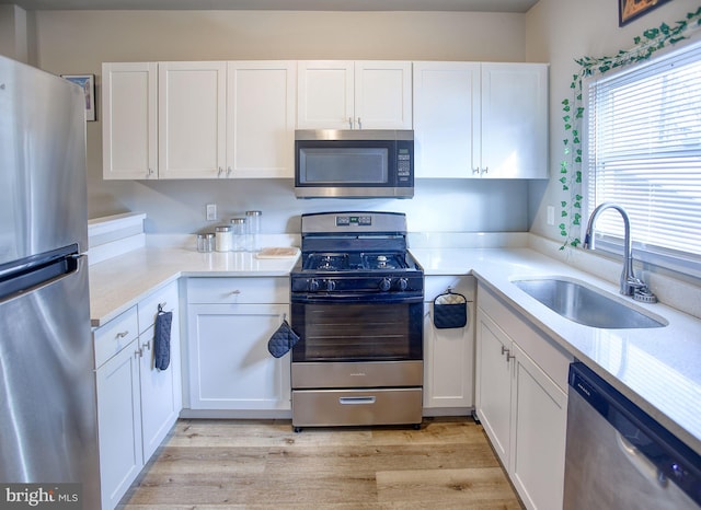 kitchen with white cabinetry, sink, and appliances with stainless steel finishes