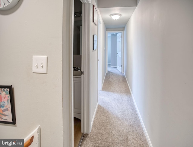 corridor featuring light colored carpet