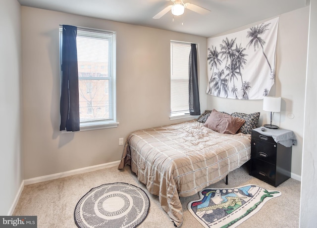 bedroom with carpet flooring, multiple windows, and ceiling fan