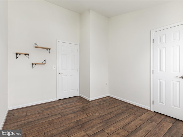 spare room with dark hardwood / wood-style floors