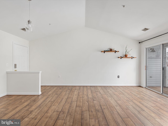 interior space featuring lofted ceiling and light hardwood / wood-style floors