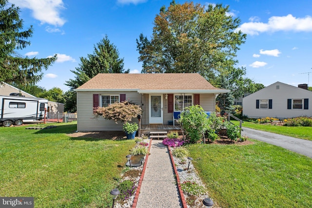 bungalow-style home featuring a porch and a front yard