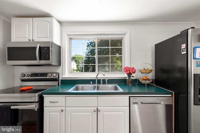 kitchen featuring crown molding, white cabinetry, sink, and appliances with stainless steel finishes