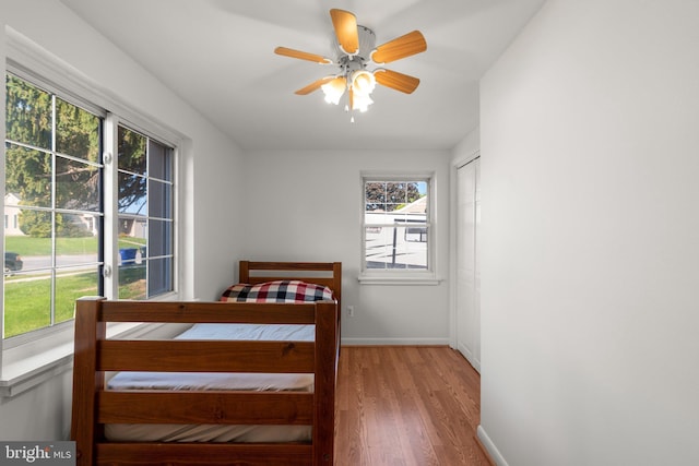 bedroom with ceiling fan and light hardwood / wood-style flooring