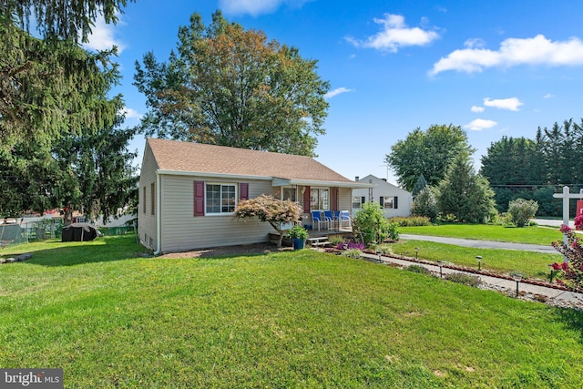 single story home featuring covered porch and a front yard