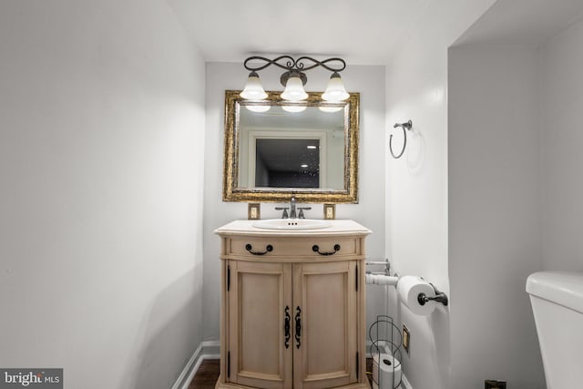 bathroom featuring vanity and toilet