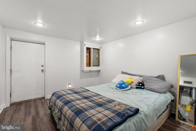 bedroom with dark wood-type flooring