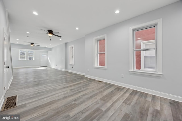 unfurnished living room featuring ceiling fan and light hardwood / wood-style floors