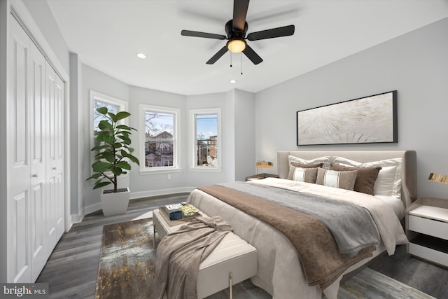 bedroom featuring dark hardwood / wood-style flooring, a closet, and ceiling fan