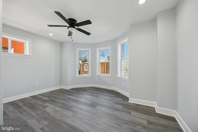 spare room featuring dark hardwood / wood-style floors and ceiling fan